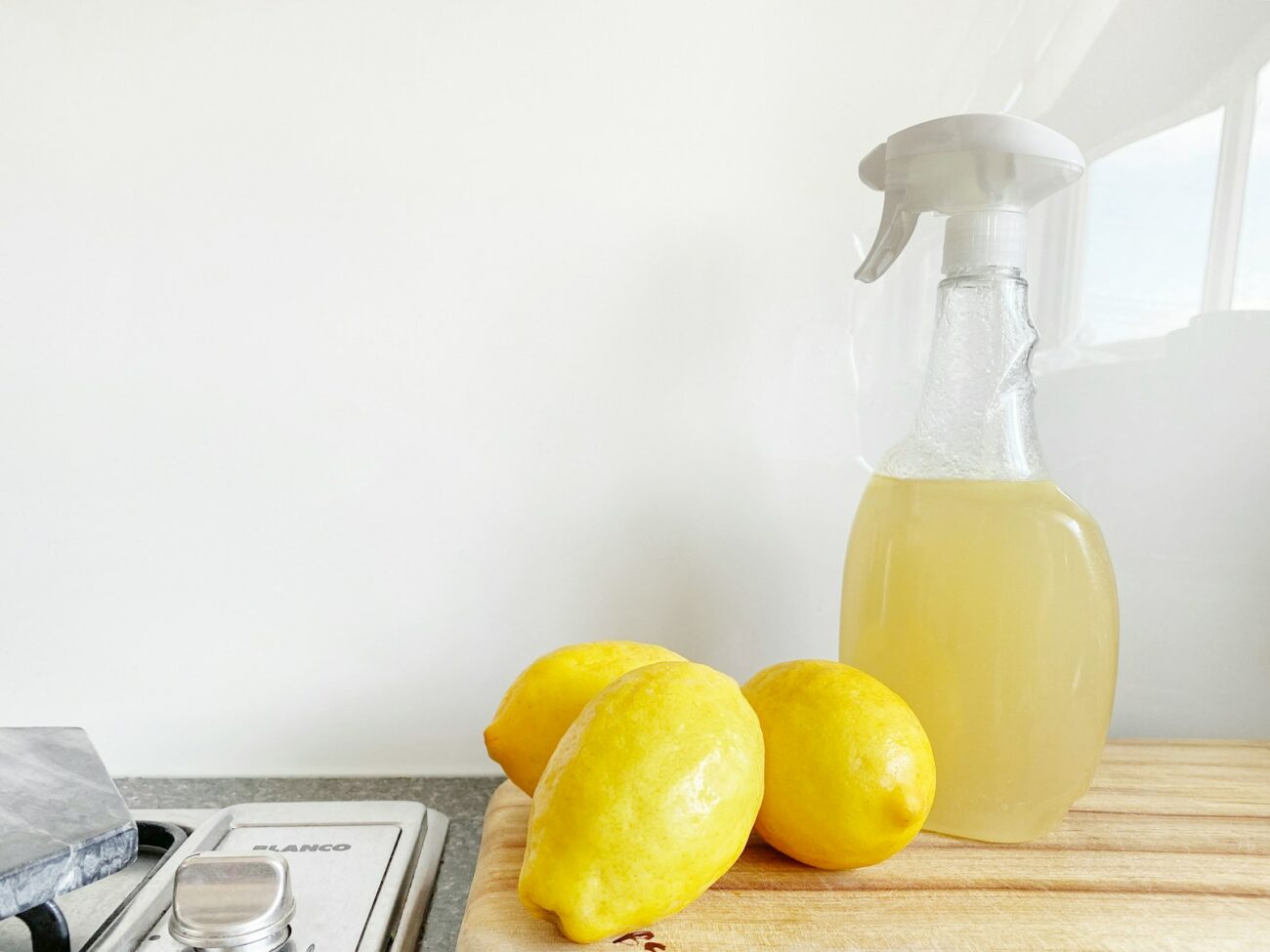 Photo by Precious Plastic Melbourne yellow lemon fruit beside clear glass bottle