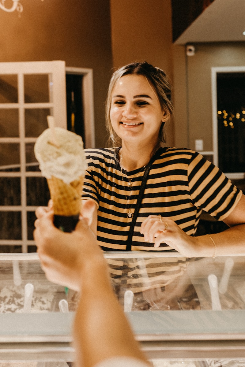Photo by Jonathan Borba smiling woman reaching for ice cream