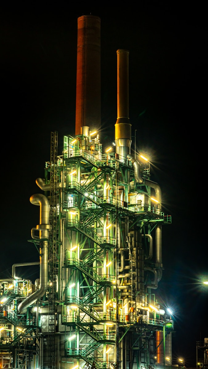 Photo by Patrick Schätz brown and black factory during night time