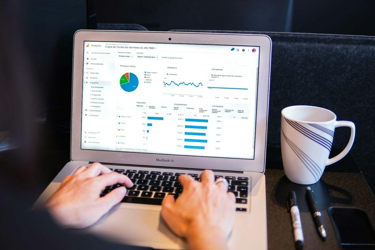 Features 5 person using macbook pro on black table