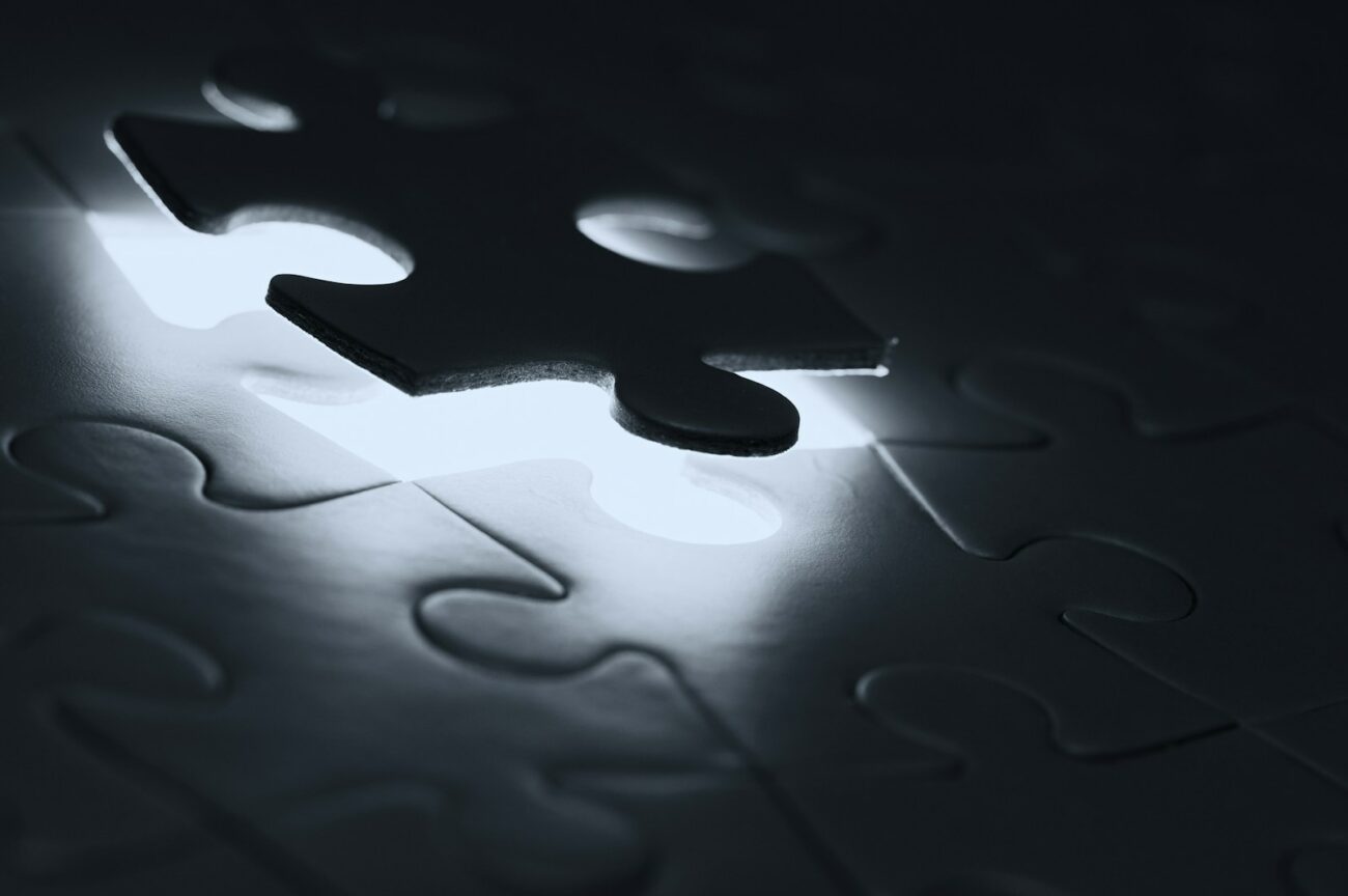 Photo by Edge2Edge Media black puzzle piece on white paper