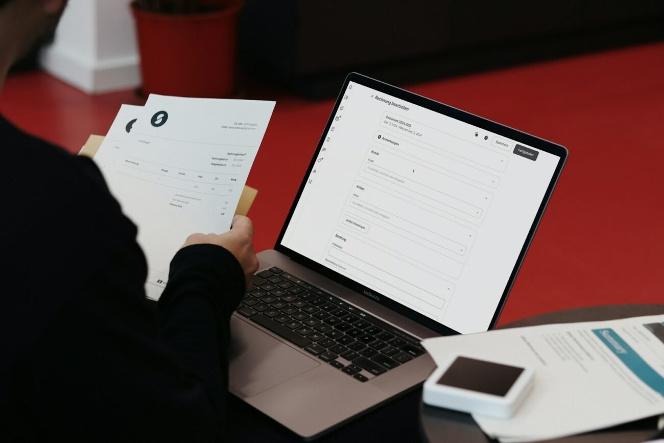 Features 6 A person sitting at a desk with a laptop and papers