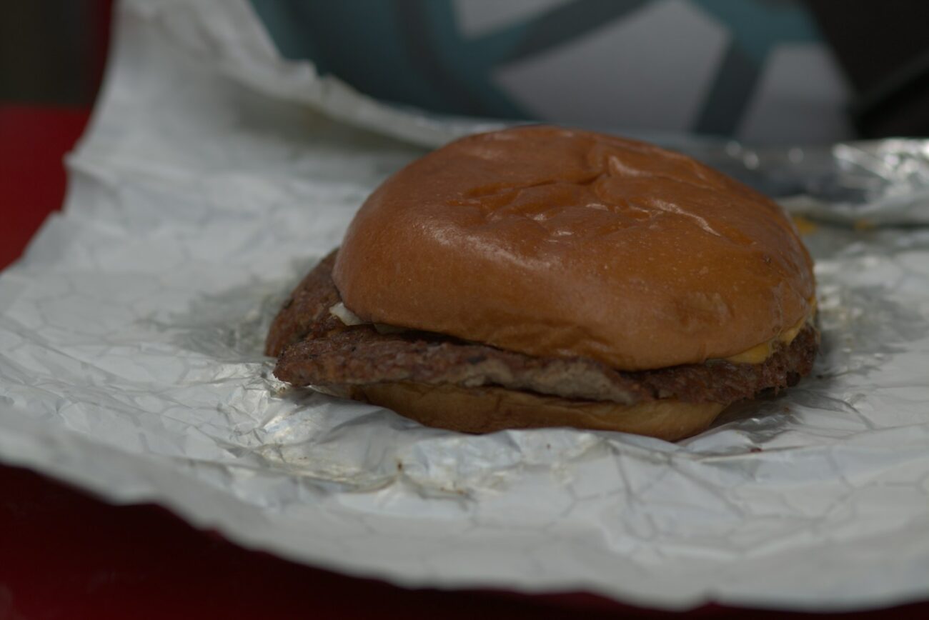 a hamburger sitting on top of a piece of tin foil