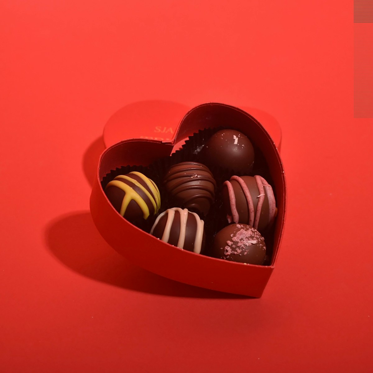 Valentine's Day heart-shaped chocolate box with premium truffles - food industry ingredients for seasonal confections