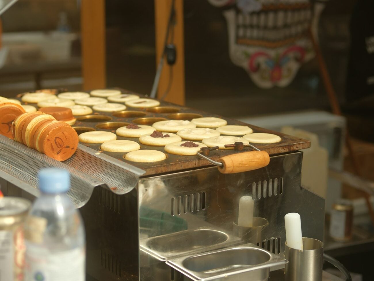 Round batter cakes cooking on a griddle