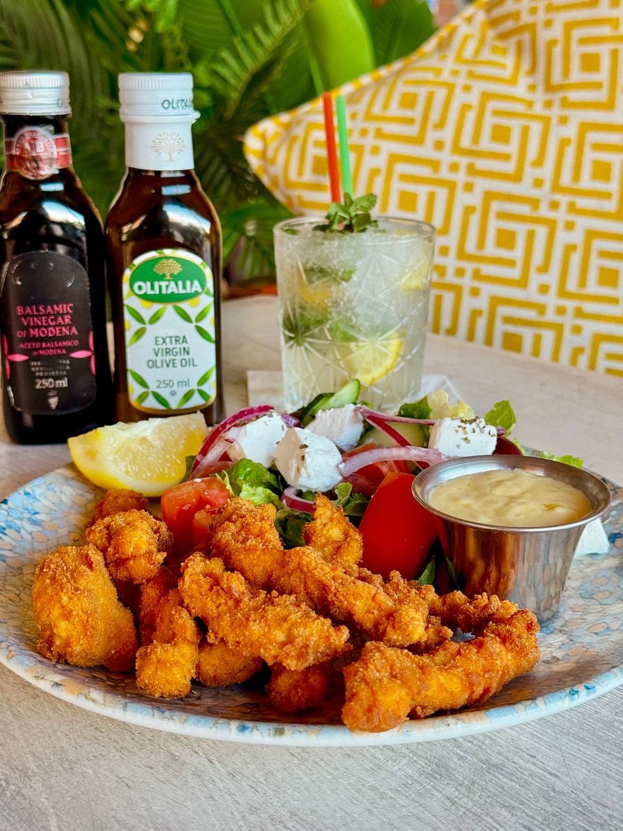 Savory crispy chicken bites served with fresh salad and a tangy lemon drink. Perfect for lunch or dinner.
